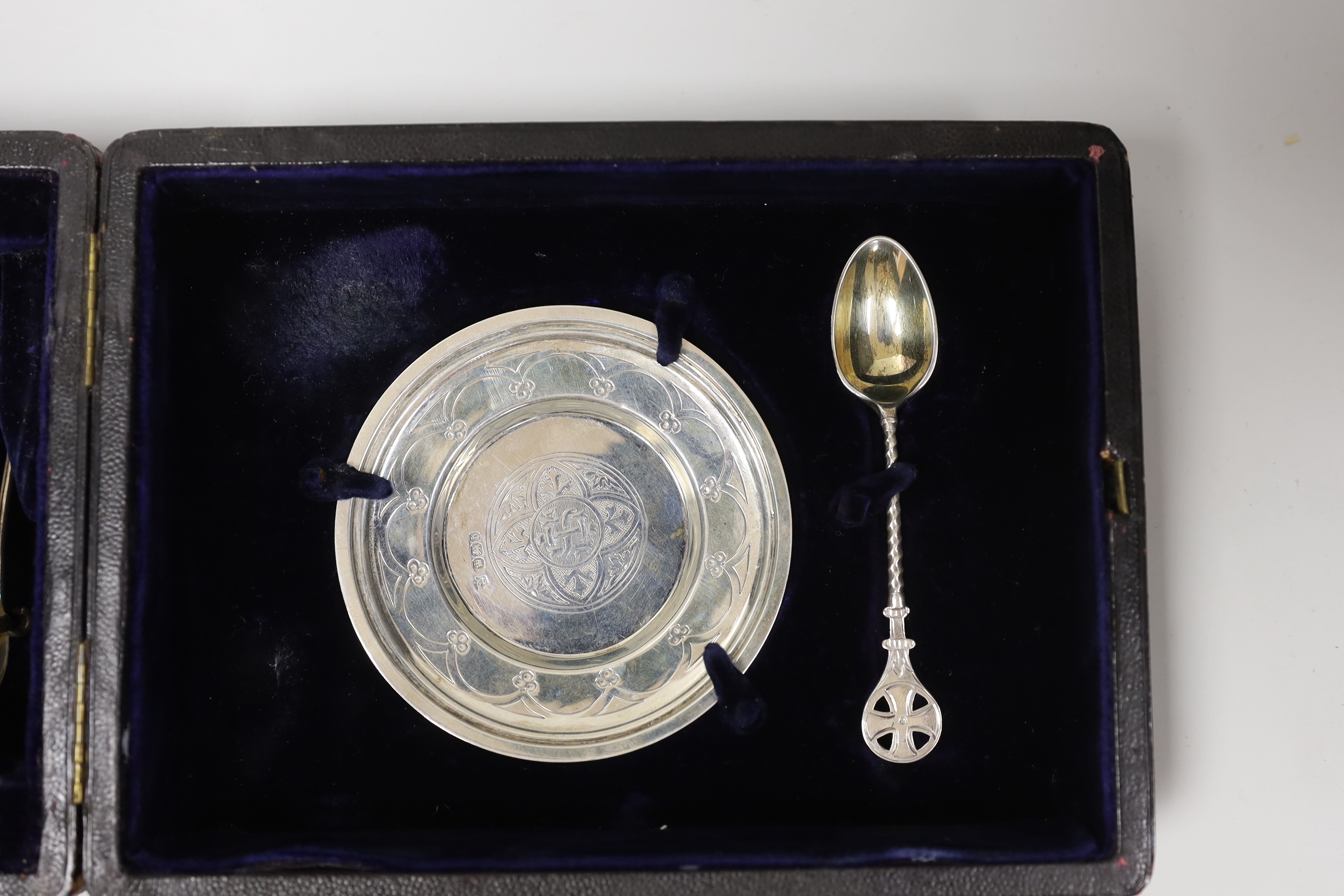 A cased late Victorian four piece silver communion set, Henry Wilkinson & Co Ltd, Sheffield, 1894, together with a matched wafer box and spoon, Walker & Hall, 1904/1906.